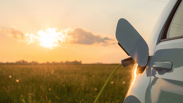 EV car charging during sunset